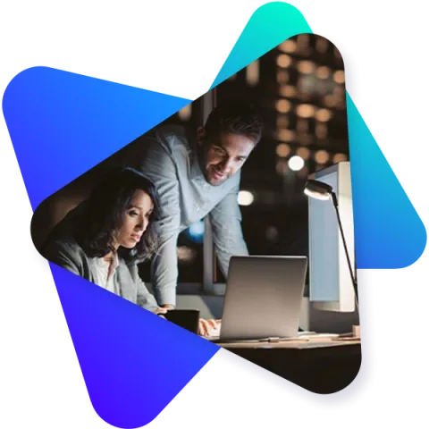 Two co-workers working on administration via laptop in a modern office